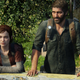 Joel and Ellie stand looking out on an overgrown balcony in the game The Last of Us.